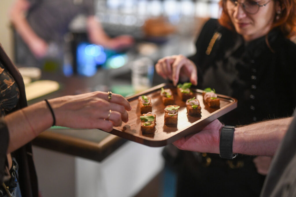Guests being served appetizers at an Eckhart Beer Co. private event in Bushwick, Brooklyn