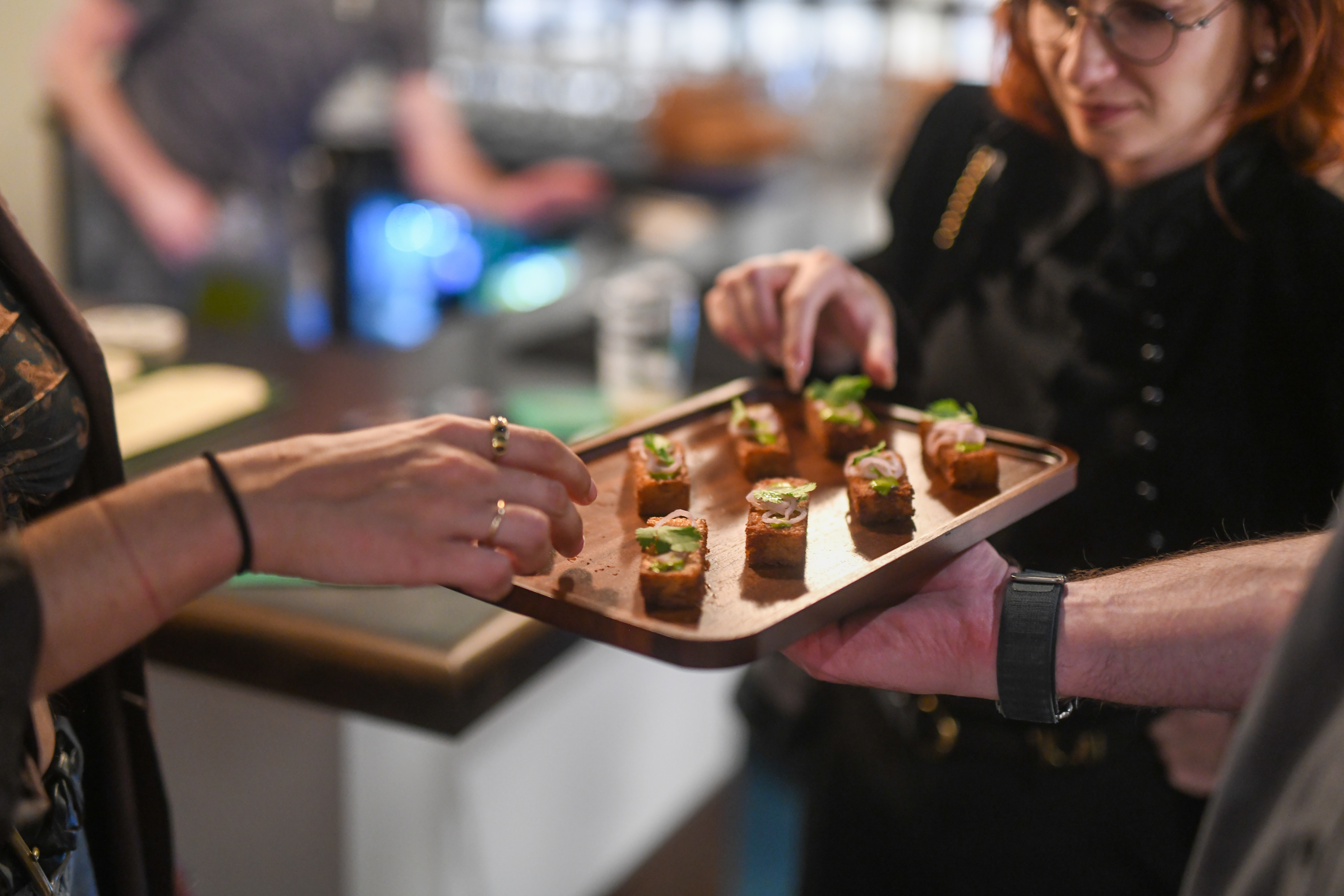 Guests being served appetizers at an Eckhart Beer Co. private event in Bushwick, Brooklyn